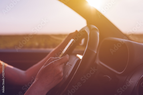 Fototapeta Naklejka Na Ścianę i Meble -  Dangerous texting while driving behavior