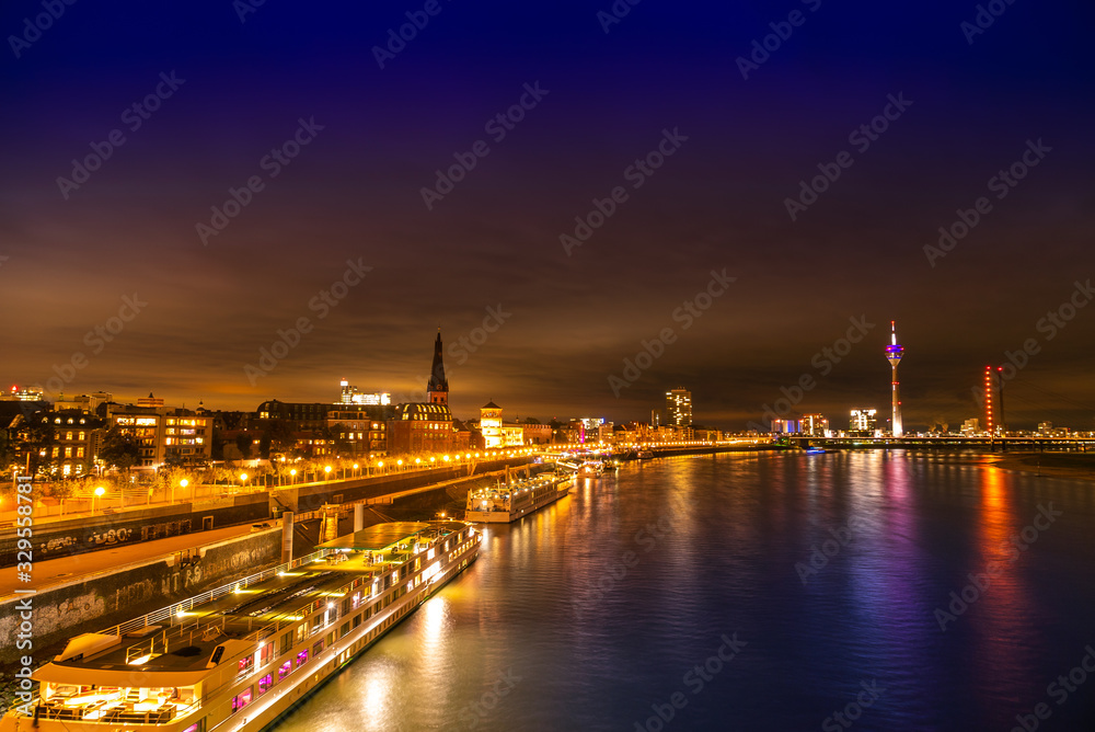 Night view of Dusseldorf on the bank of Rhine in Germany; peaceful lake and bright buildings