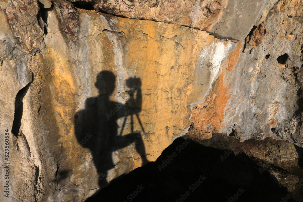 The shadow of the photographer on the limestone cave wall