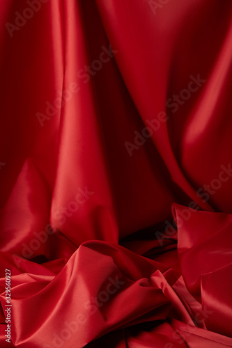 close up view of red soft and crumpled silk textured cloth