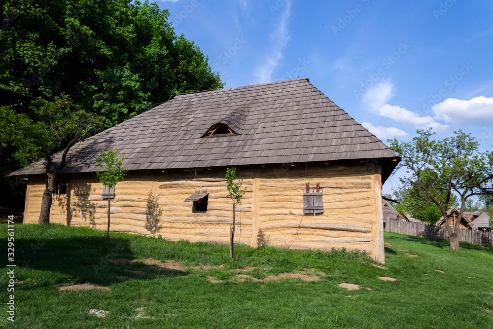 Fototapeta premium Traditional medieval wooden buildings at archaeological heritage village near Velehrad Monastery, Modra, Moravia, Czech Republic, sunny summer day