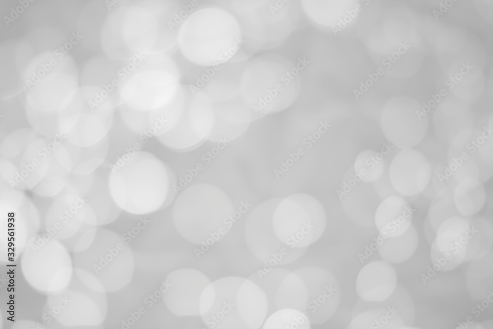 White glitter vintage lights background. White bokeh on background.