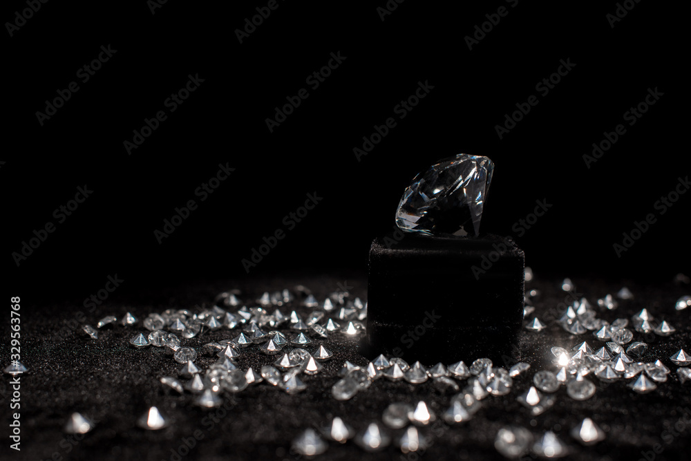 Diamond near gemstones on black velour isolated on black Diamond near gemstones on black velour isolated on black