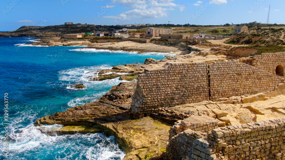 Flight over ancient ruins at the coast of Malta - aerial photography