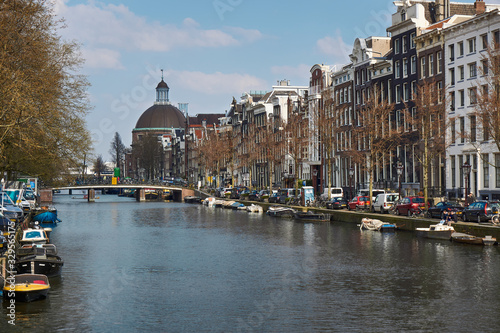 Amsterdam Canal Views of the canal with clouds in the sky and sunny day Interesting buildings