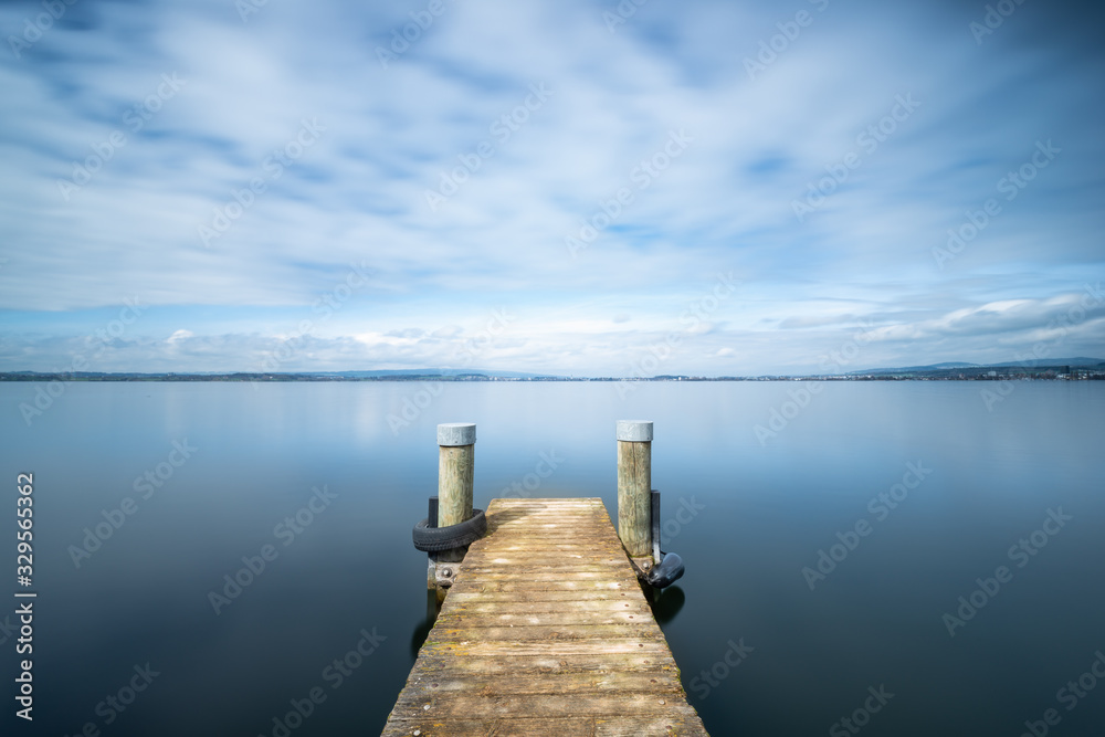 Fototapeta premium Long exposure landscape. Pier on the lake.
