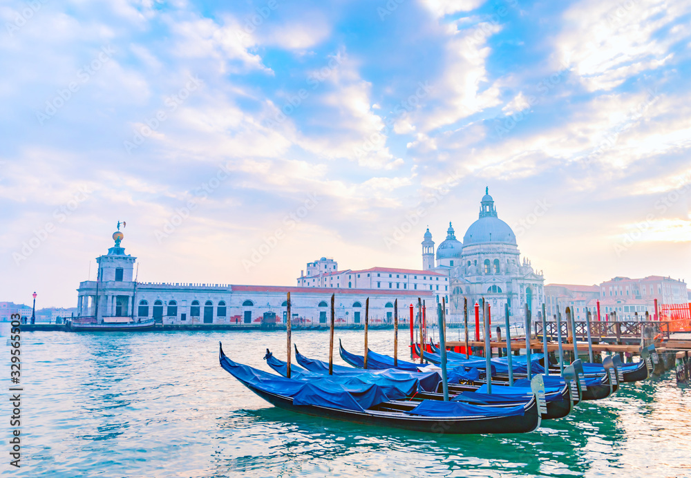 Venetian gondolas on Grand Canal with Santa Maria della Salute Basilica in the background, Venice, Italy