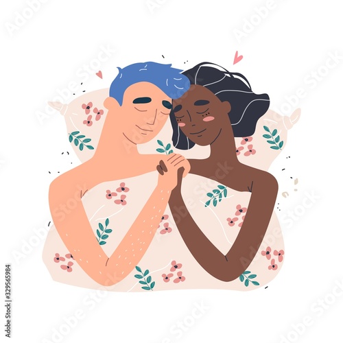 Lovers man and black african american woman hug lying in bed . Happy multiracial family concept.