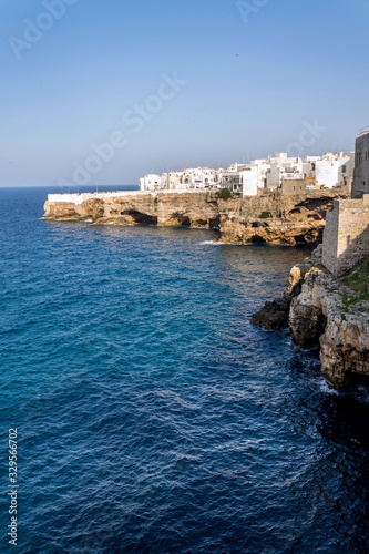 Houses on dramatic cliffs over Adriatic sea in Polignano a Mare, Italy, sunny summer day