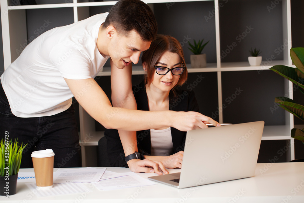Loving couple working successfully together on their own business Loving couple working successfully together on their own business