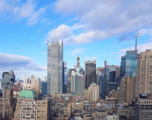 New York City cityscape with tall buildings, beautiful blue sky with clouds
