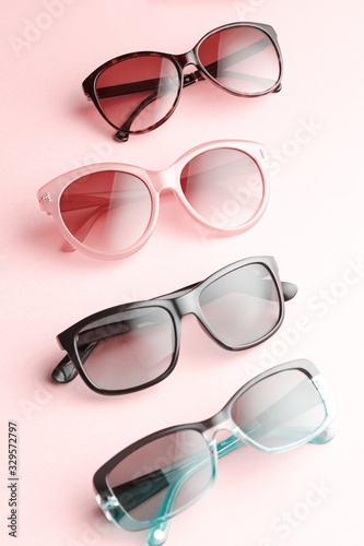 Sunglasses of various forms and colors in a row. Flat lay with fashion accessory sunglasses