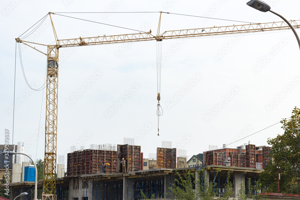 Industrial background made of crane construction at the buildings background at the building area