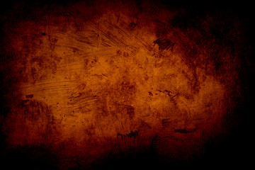 orange grunge background or texture with black vignette borders
