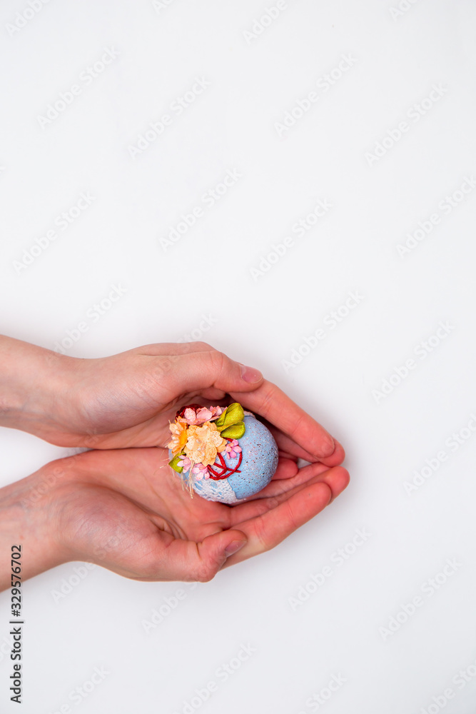 Easter egg in hands on a white isolated background. Easter egg in hands on a white isolated background.