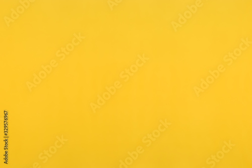 Blur photo of yellow. Empty bright background creating a spring mood. The color of mimosa or gold.