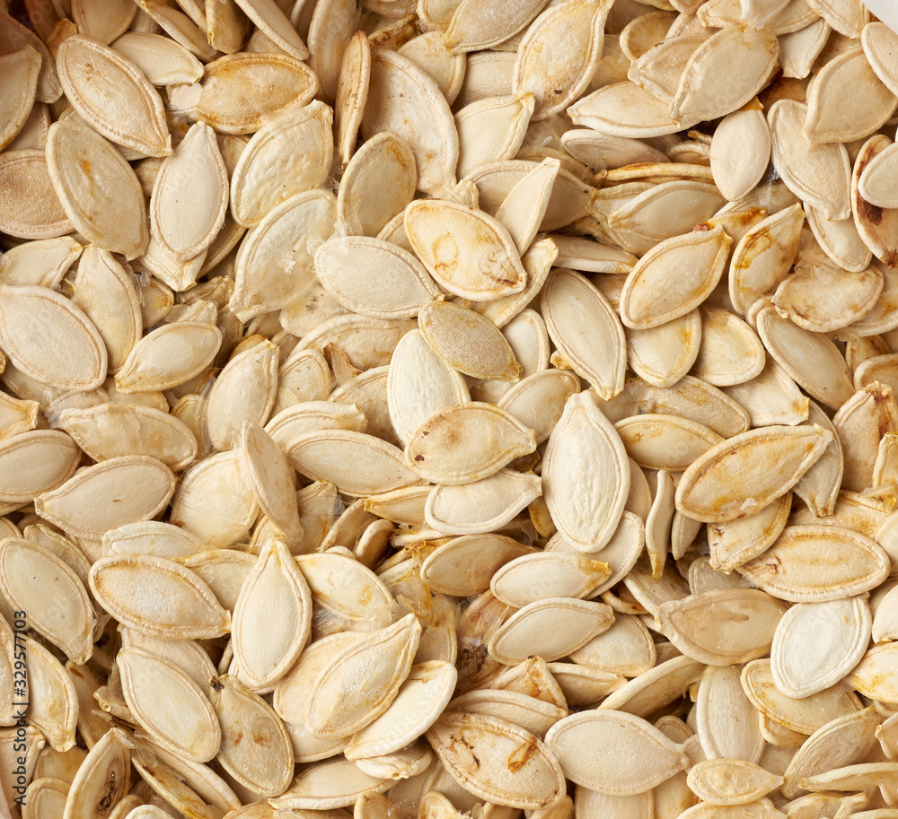 dry raw pumpkin seeds, full frame dry raw pumpkin seeds, full frame