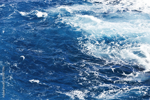 Ocean wave background. Bubble water foam backdrop. Turbulent sea texture. Messy water flow.