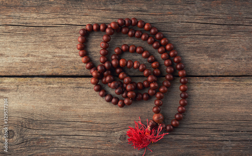 Konstfotografi brown wooden prayer rosary on a wooden background from gray old planks