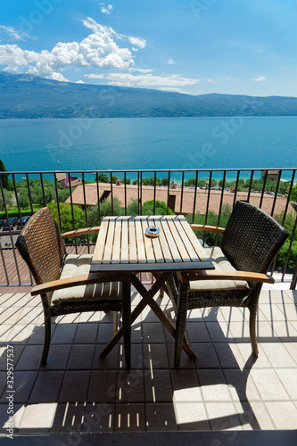 Balcony with table and chairs with view on Garda Lake in Gargnano in Italy © Roman Babakin