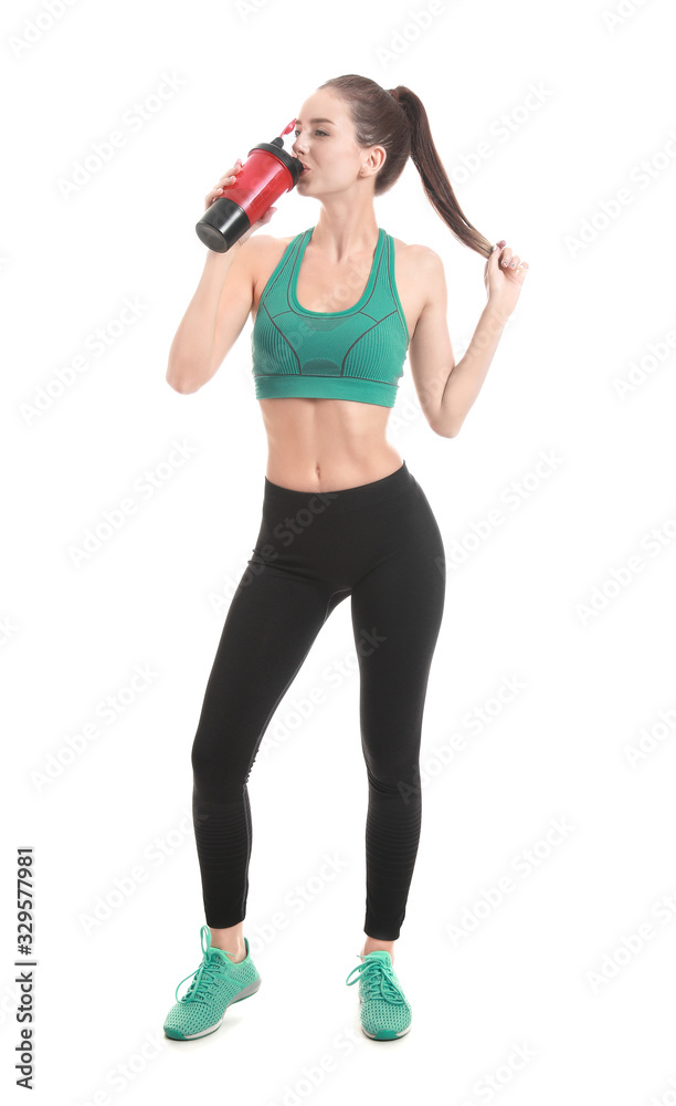 Sporty young woman with protein shake on white background Sporty young woman with protein shake on white background