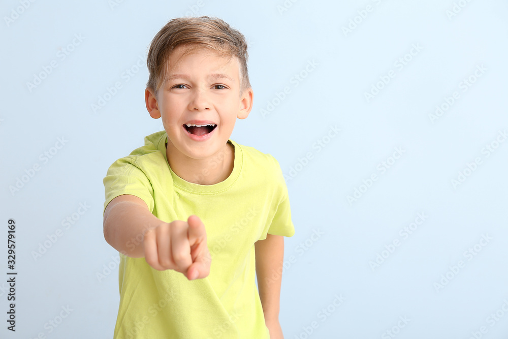 Happy little boy pointing at viewer on white background Happy little boy pointing at viewer on white background