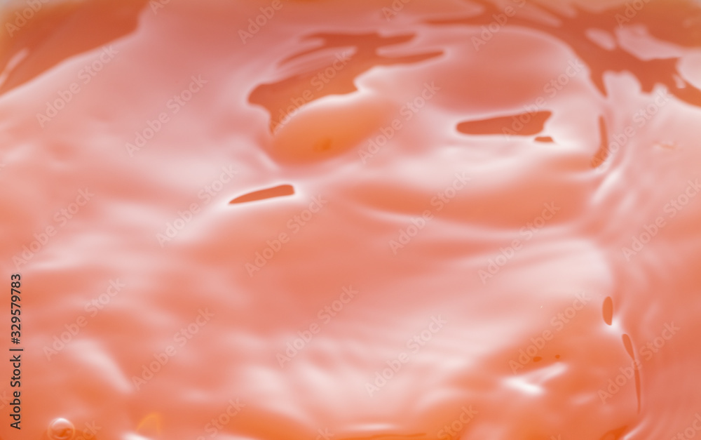 a swirling wave on the surface of grapefruit juice. a swirling wave on the surface of grapefruit juice.