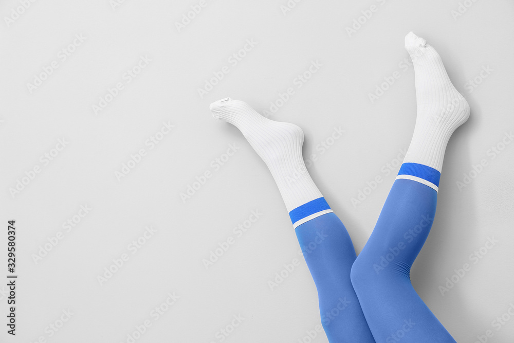 Legs of young woman in socks and tights on light background Legs of young woman in socks and tights on light background