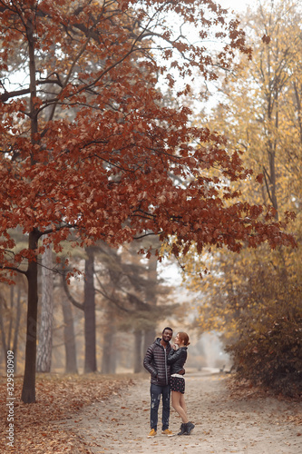 Happy interracial couple posing in autumn park