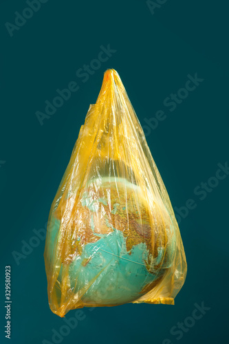 A globe in plastic bag. Earth pollution and environment pritection concept photo