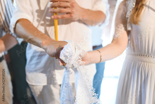 hands of couple fixed by towel at church © photographmd