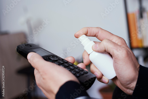 Wallpaper Mural man disinfecting a portable telephone Torontodigital.ca
