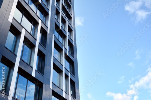 Modern office building facade abstract fragment, shiny windows in steel structure