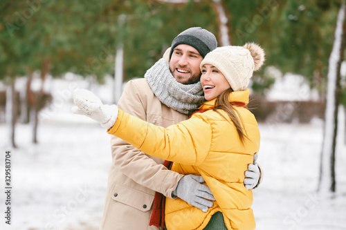Happy young couple in park ...