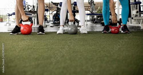 Fotografija people working out with kettlebell in the gym