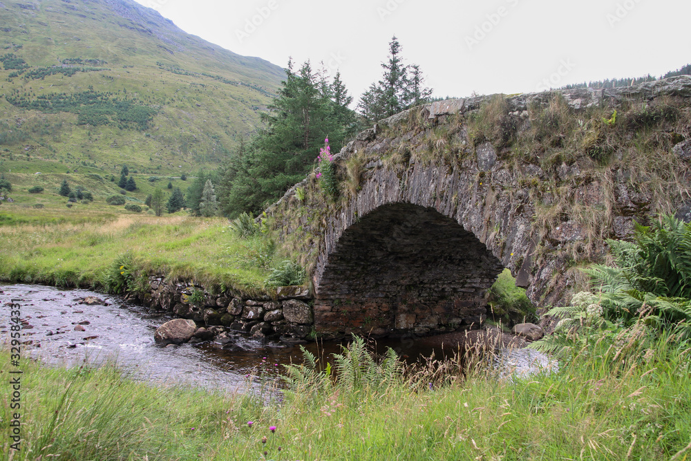  old small bridge over a small mountain river
