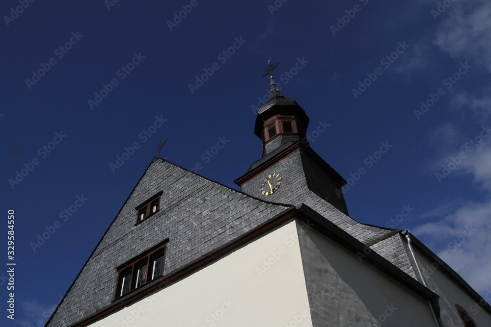 small church tower against a dark blue sky as a background