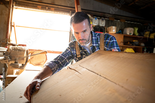 Carpenter working on woodworking in carpentry workshop