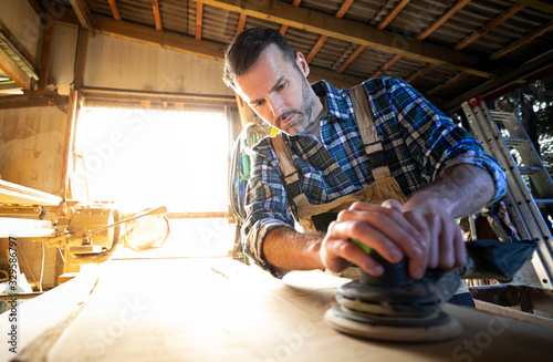 Carpenter working on woodworking in carpentry workshop