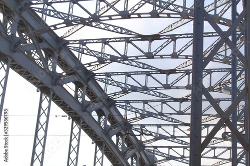 Structural elements of an old steel bridge. Arches and farms riveted.