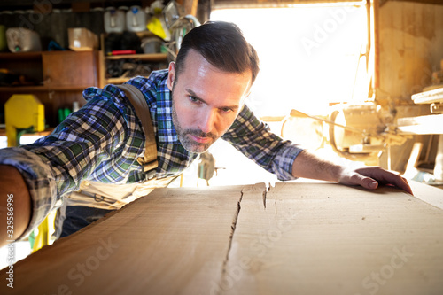 Carpenter working on woodworking in carpentry workshop