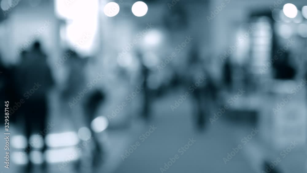 Many people walk inside the mall exhibition store. Blurred Background Many people walk inside the mall exhibition store. Blurred Background