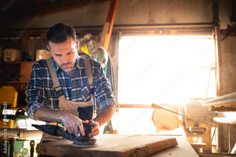 Carpenter working on woodworking in carpentry workshop Carpenter working on woodworking in carpentry workshop