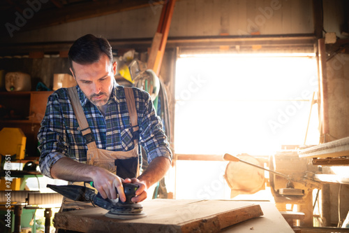 Carpenter working on woodworking in carpentry workshop