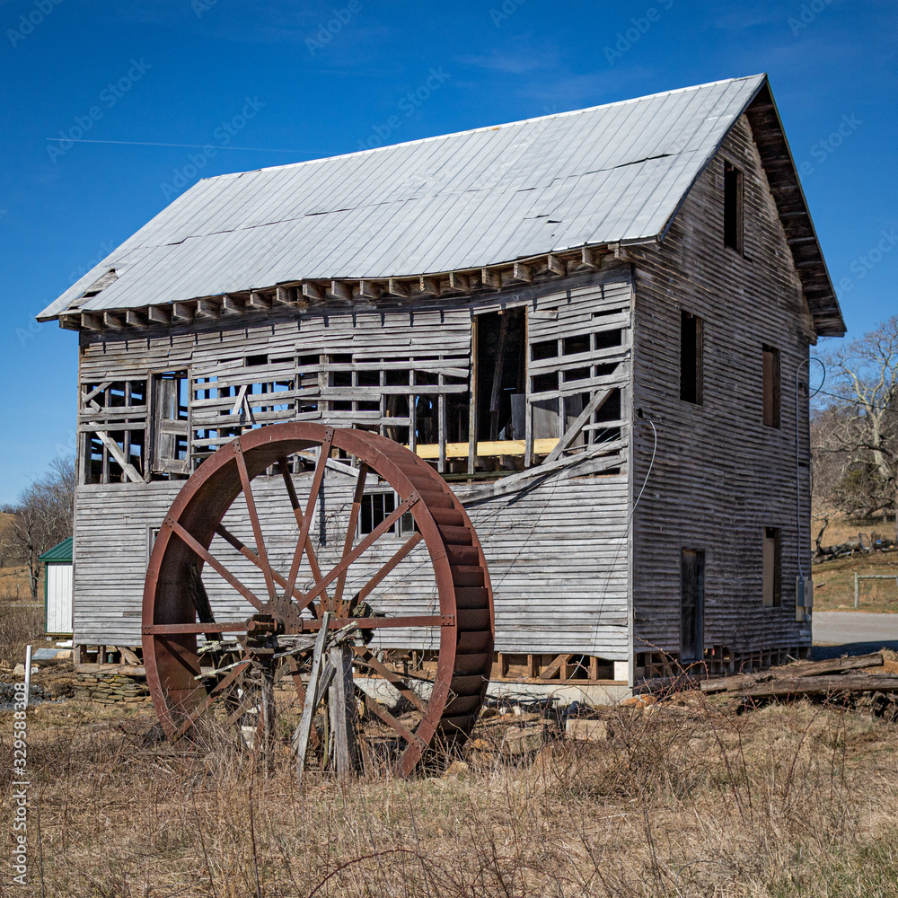 Fototapeta premium old abandoned mill with waterwheel 