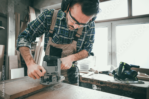 Carpenter working on woodworking in carpentry workshop