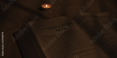 Open bible with candle  photo