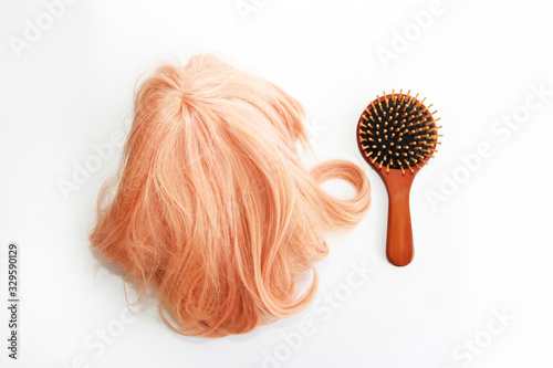 Obraz na plátně spoiled curls hair blonde wig and wooden brown massage a comb