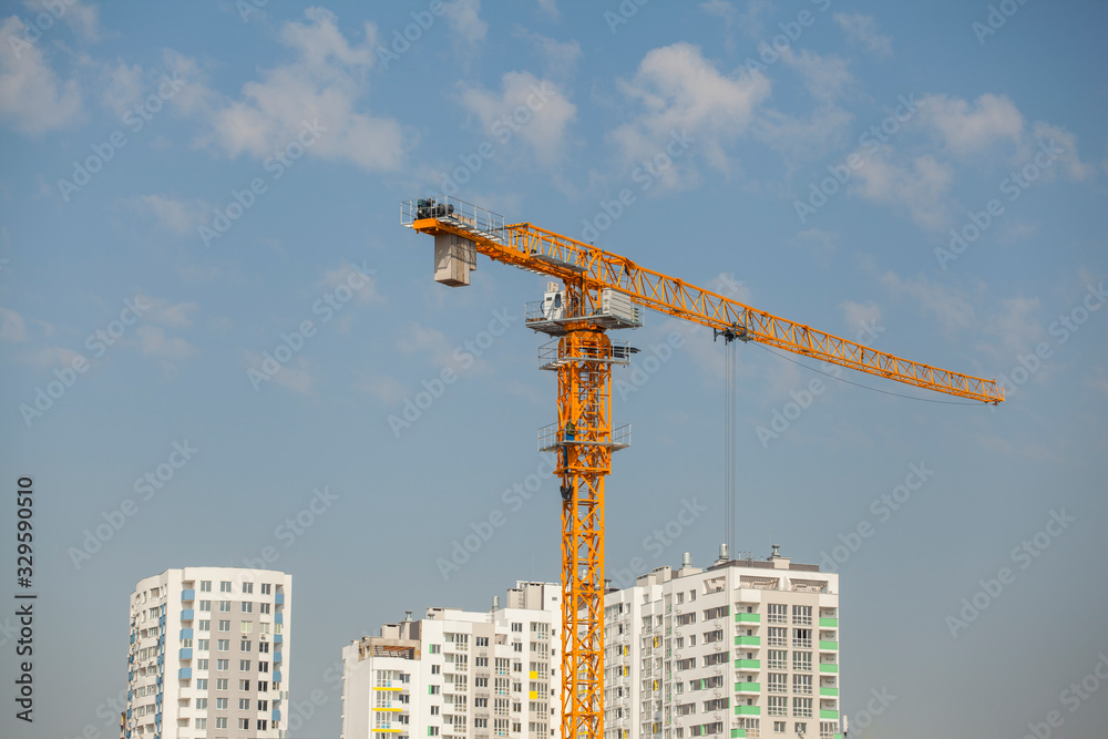 Construction site with crane against the blue sky	