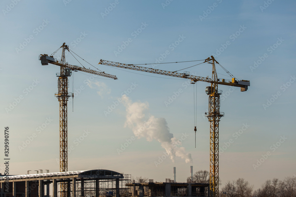 construction cranes against the blue sky	